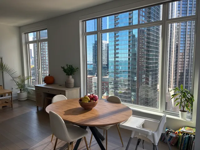 a dining room with furniture window and wooden floor