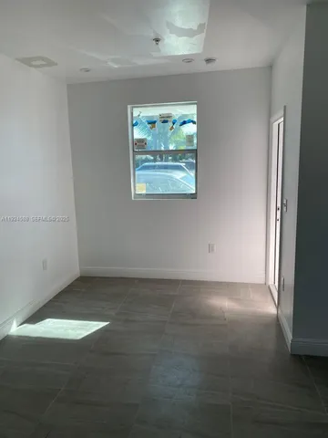 an empty room with an empty space and window