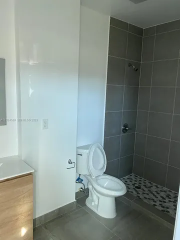 a white toilet sitting next to a bathroom sink