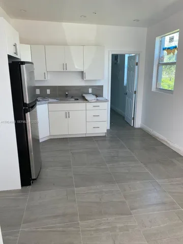 a kitchen with stainless steel appliances a refrigerator sink and microwave