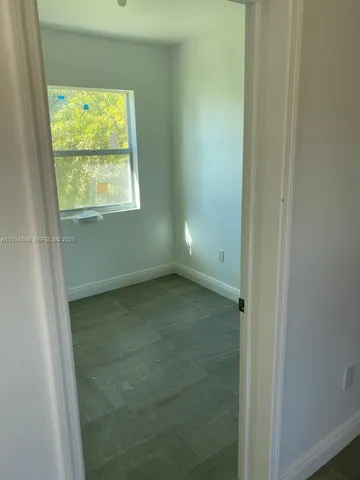 a kitchen with granite countertop a sink a stove a refrigerator and cabinets