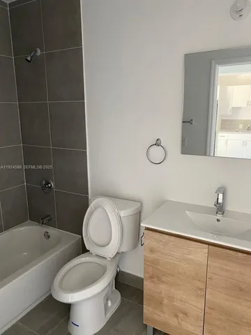 a kitchen with granite countertop white cabinets and white stainless steel appliances