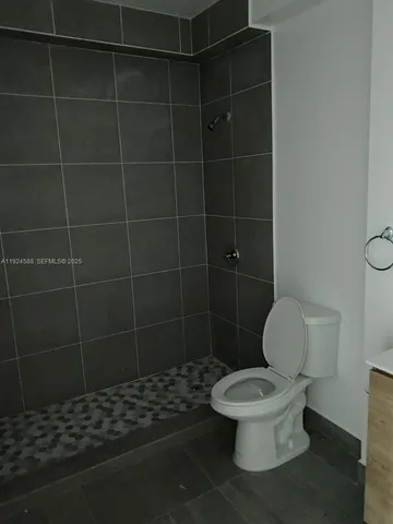 a white toilet sitting next to a bathroom sink