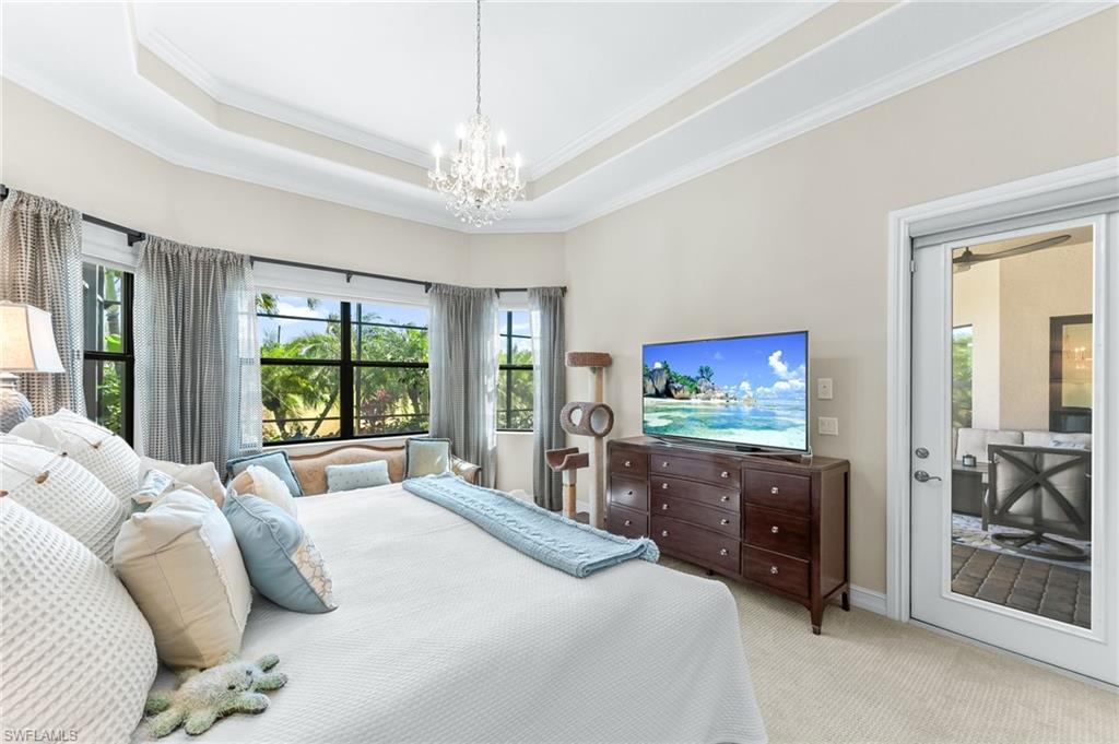 6818 Canwick Cove Circle Naples, FL 34113 - Photo 14 of 44 Carpeted bedroom featuring ornamental molding, suspended lighting, access to outside, and a tray ceiling