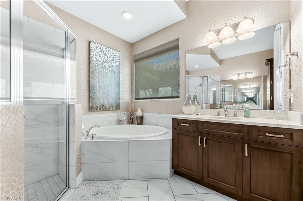 6818 Canwick Cove Circle Naples, FL 34113 - Photo 15 of 44 Full bath with a shower stall, a garden tub, and vanity