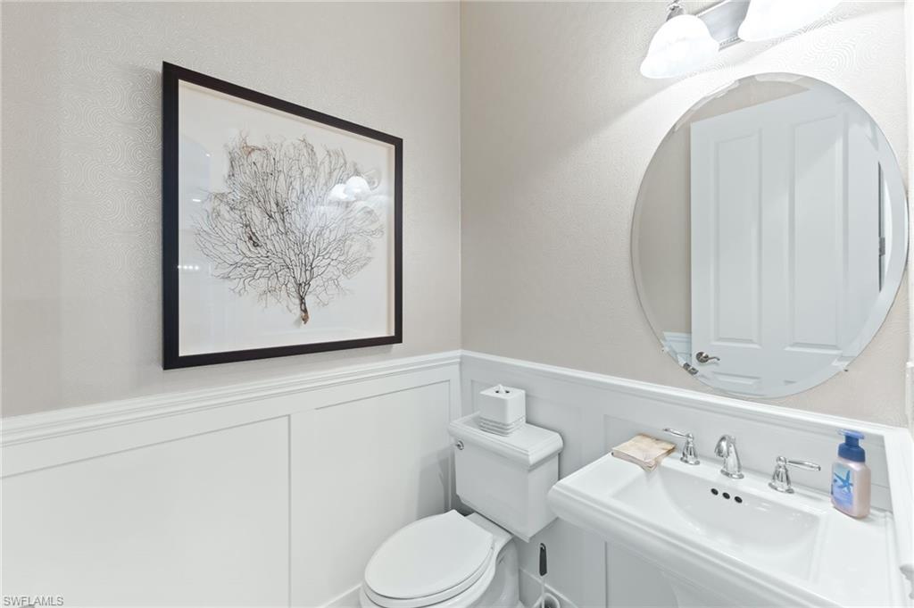 6818 Canwick Cove Circle Naples, FL 34113 - Photo 17 of 44 Bathroom featuring a wainscoted wall and a decorative wall