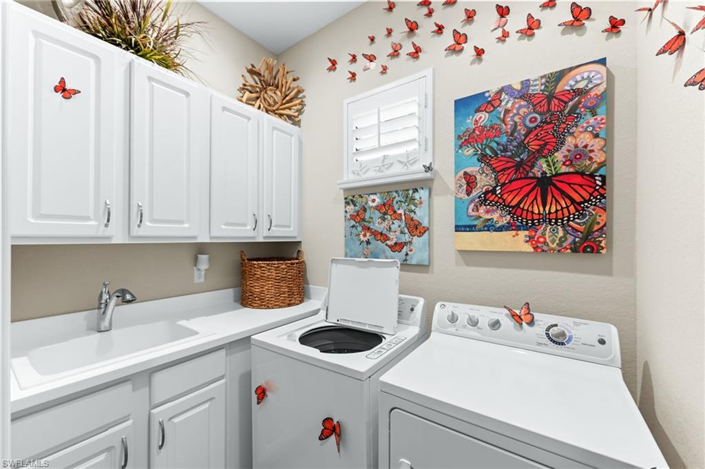 6818 Canwick Cove Circle Naples, FL 34113 - Photo 18 of 44 Laundry area featuring separate washer and dryer and cabinet space