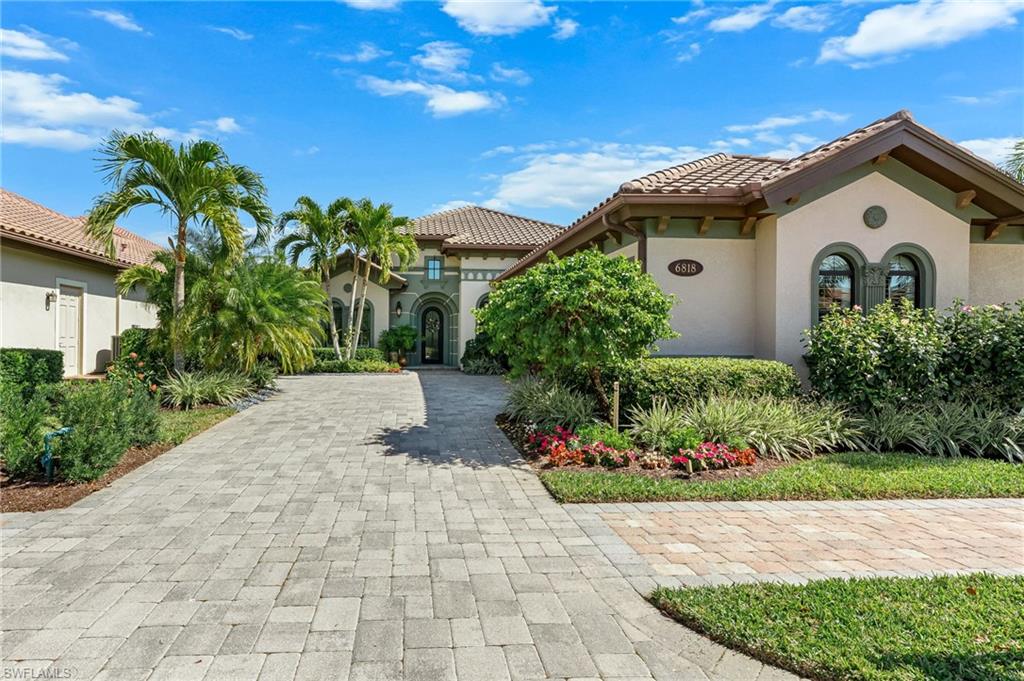 6818 Canwick Cove Circle Naples, FL 34113 - Photo 2 of 44 View of front facade with stucco siding, decorative driveway, and a tile roof