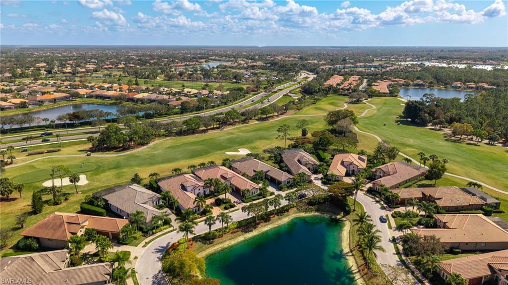 6818 Canwick Cove Circle Naples, FL 34113 - Photo 25 of 44 Aerial perspective of suburban area featuring a nearby body of water and a local golf course