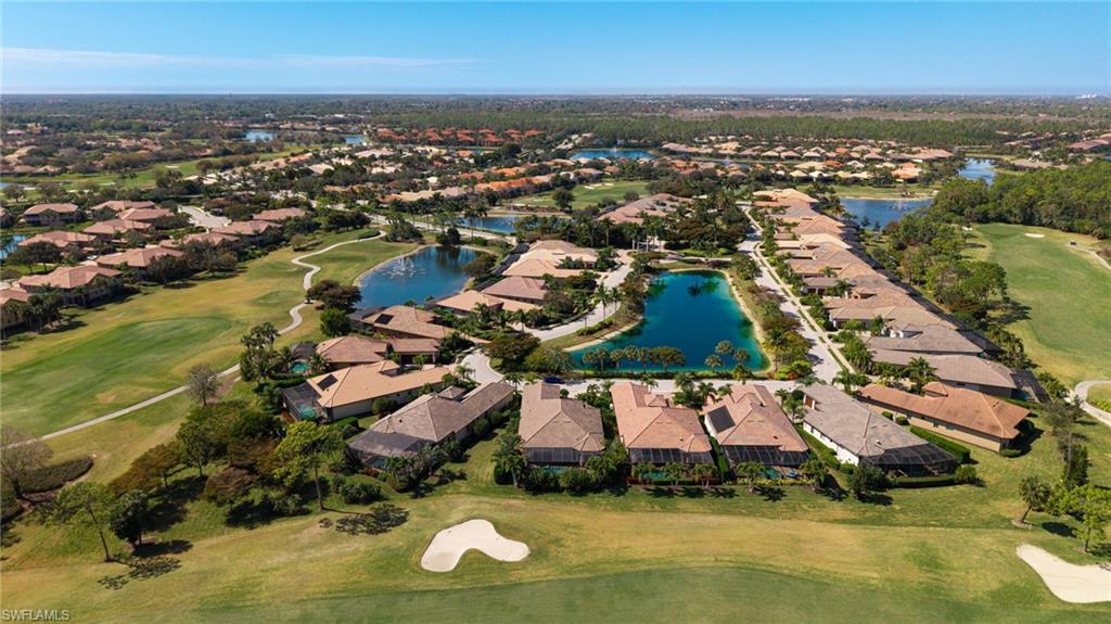 6818 Canwick Cove Circle Naples, FL 34113 - Photo 27 of 44 Aerial view of residential area featuring a golf club and a nearby body of water