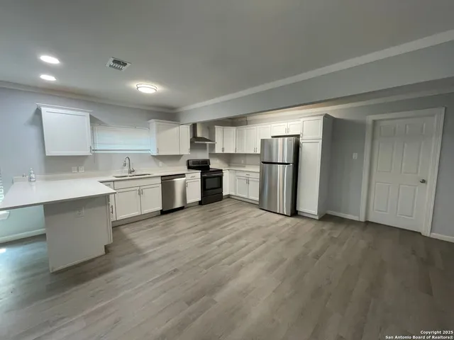 a view of kitchen with wooden floor
