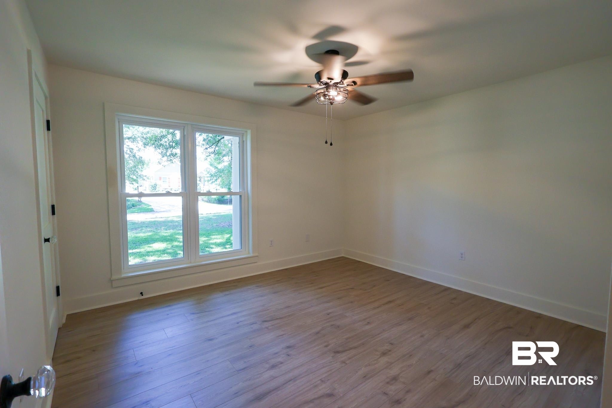 12190 Pecan Grove Street Magnolia Springs, AL 36555 - Photo 13 of 45 Spare room featuring ceiling fan, hardwood / wood-style flooring, and plenty of natural light