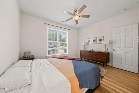 a bedroom with a bed and wooden floor