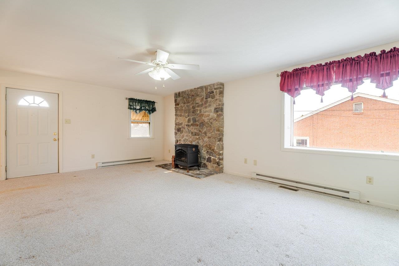 179 3rd Street Broadway, VA 22815 - Photo 13 of 38 an empty room with windows and fireplace