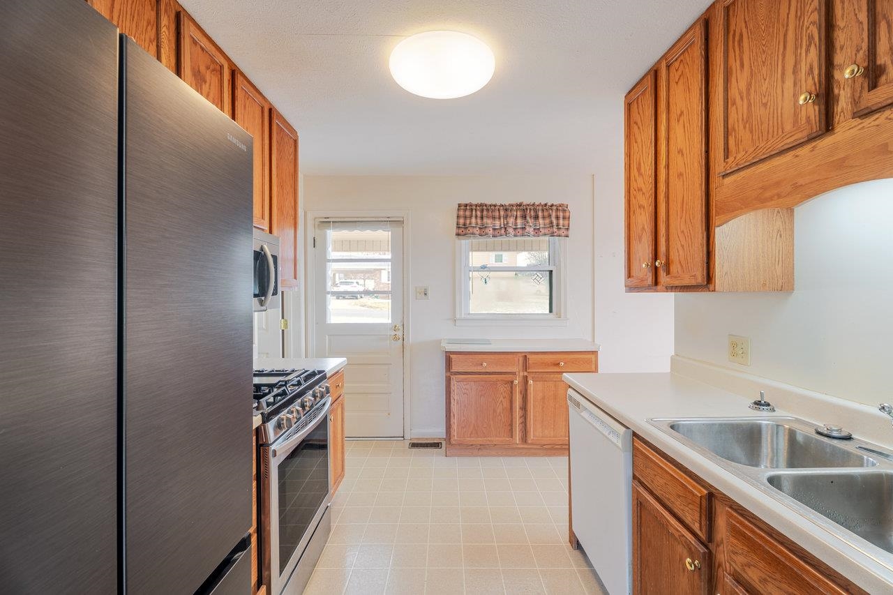179 3rd Street Broadway, VA 22815 - Photo 14 of 38 a kitchen with stainless steel appliances a sink stove and cabinets
