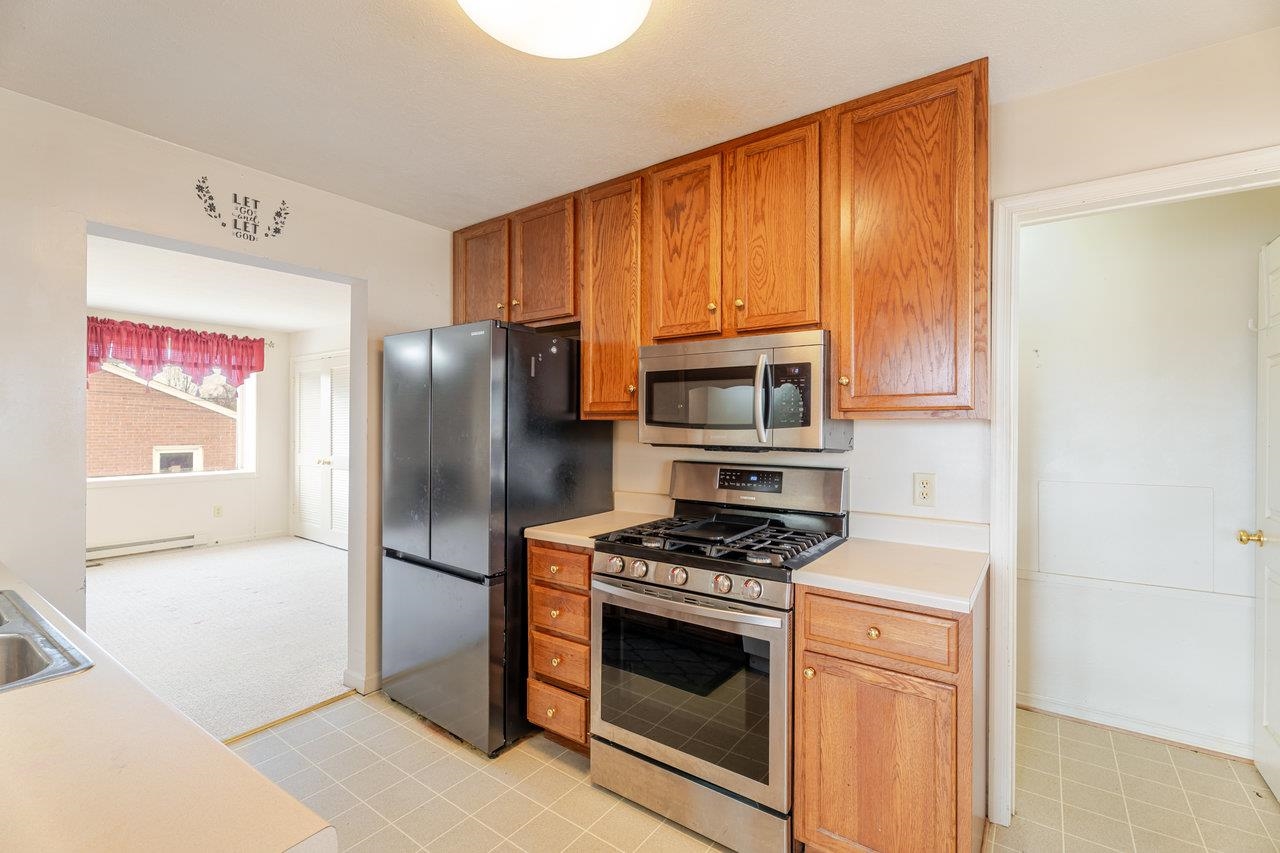179 3rd Street Broadway, VA 22815 - Photo 16 of 38 a kitchen with stainless steel appliances granite countertop a refrigerator stove and microwave