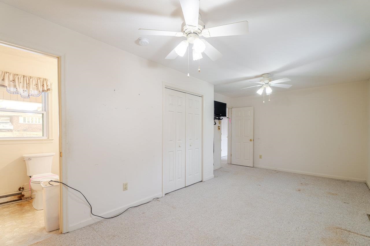 179 3rd Street Broadway, VA 22815 - Photo 22 of 38 an empty room with a ceiling fan and window