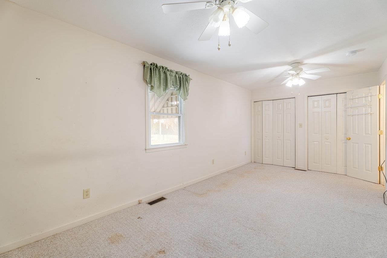 179 3rd Street Broadway, VA 22815 - Photo 25 of 38 an empty room with chandelier fan and windows