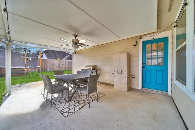 a view of a patio with a table and chairs