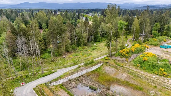 an aerial view of a house with swimming pool and garden
