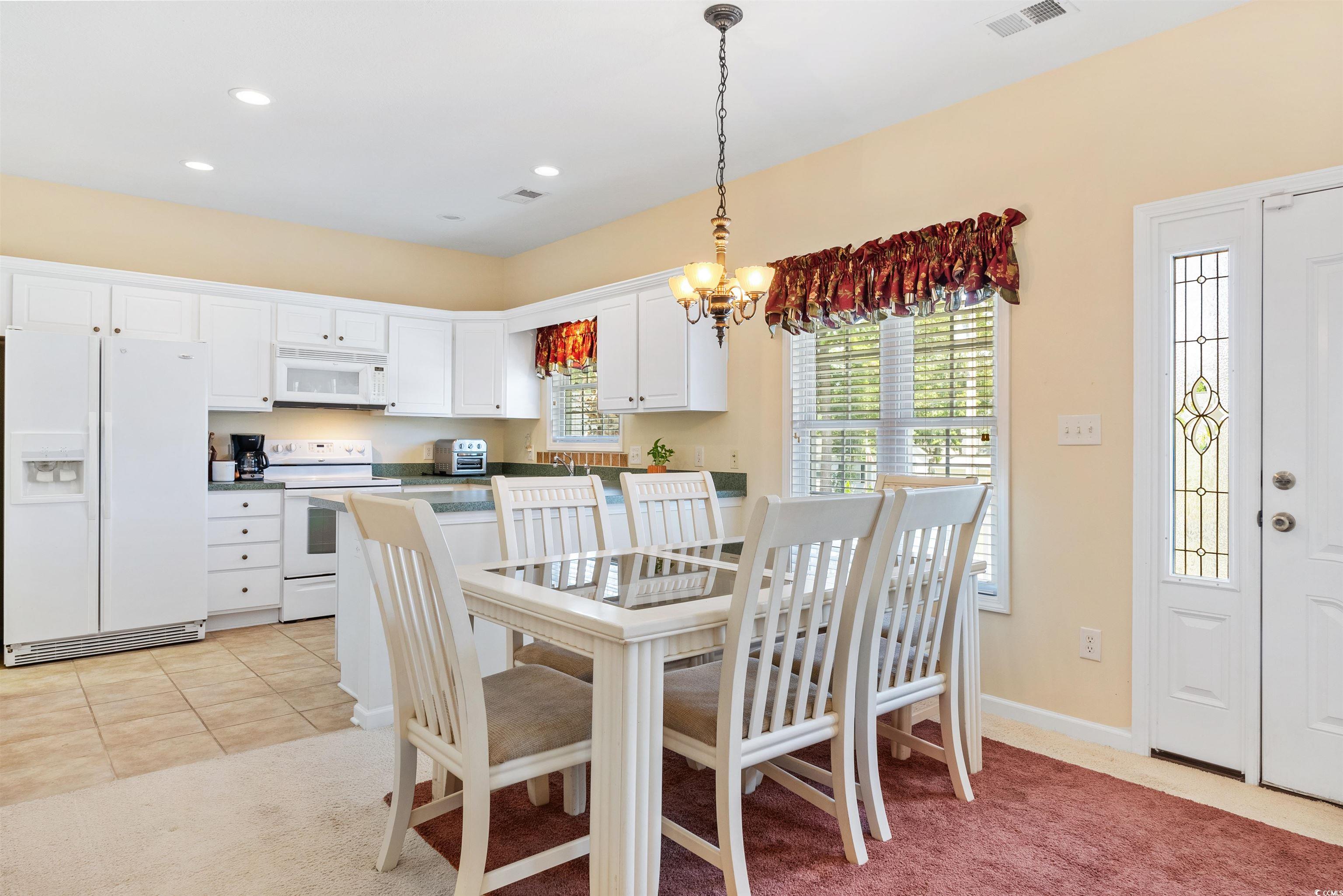 513 Rainbow Drive Murrells Inlet, SC 29576 - Photo 10 of 29 Dining area featuring a chandelier and light carpe