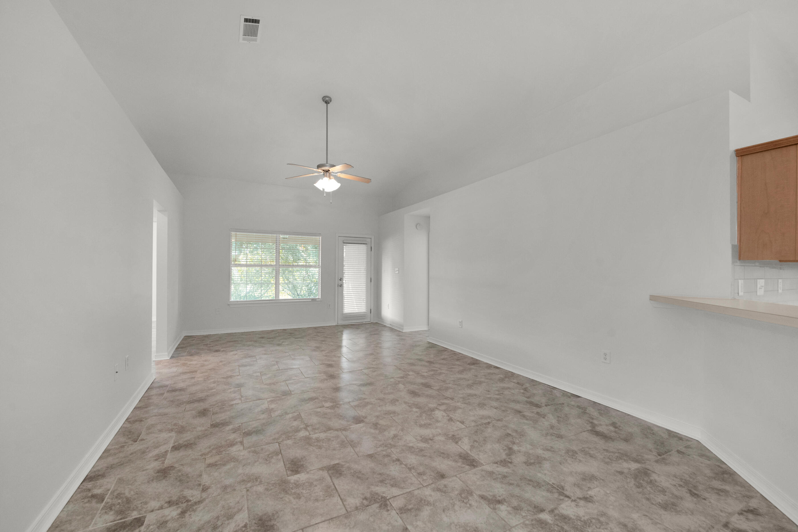 161 South Harborview Road Santa Rosa Beach, FL 32459 - Photo 10 of 39 an empty room with windows and chandelier fan