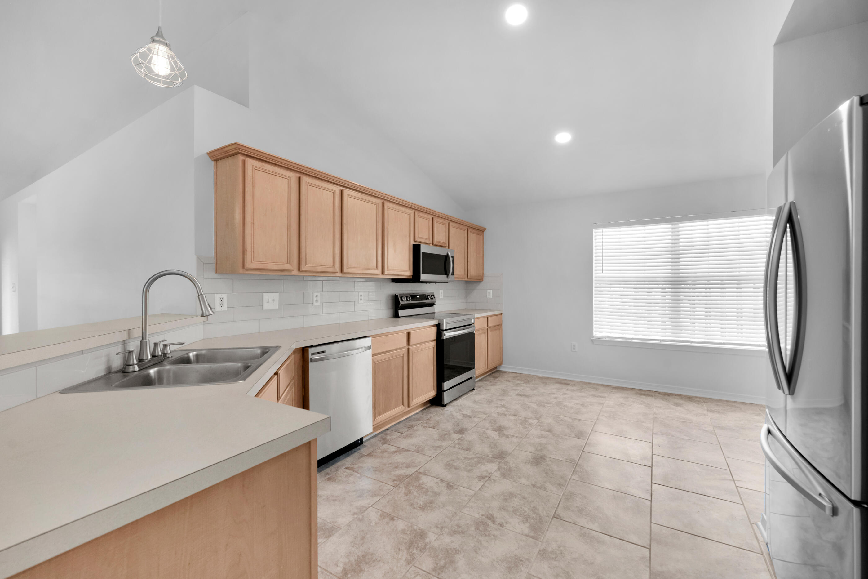 161 South Harborview Road Santa Rosa Beach, FL 32459 - Photo 15 of 39 a kitchen with stainless steel appliances granite countertop a sink stove and refrigerator