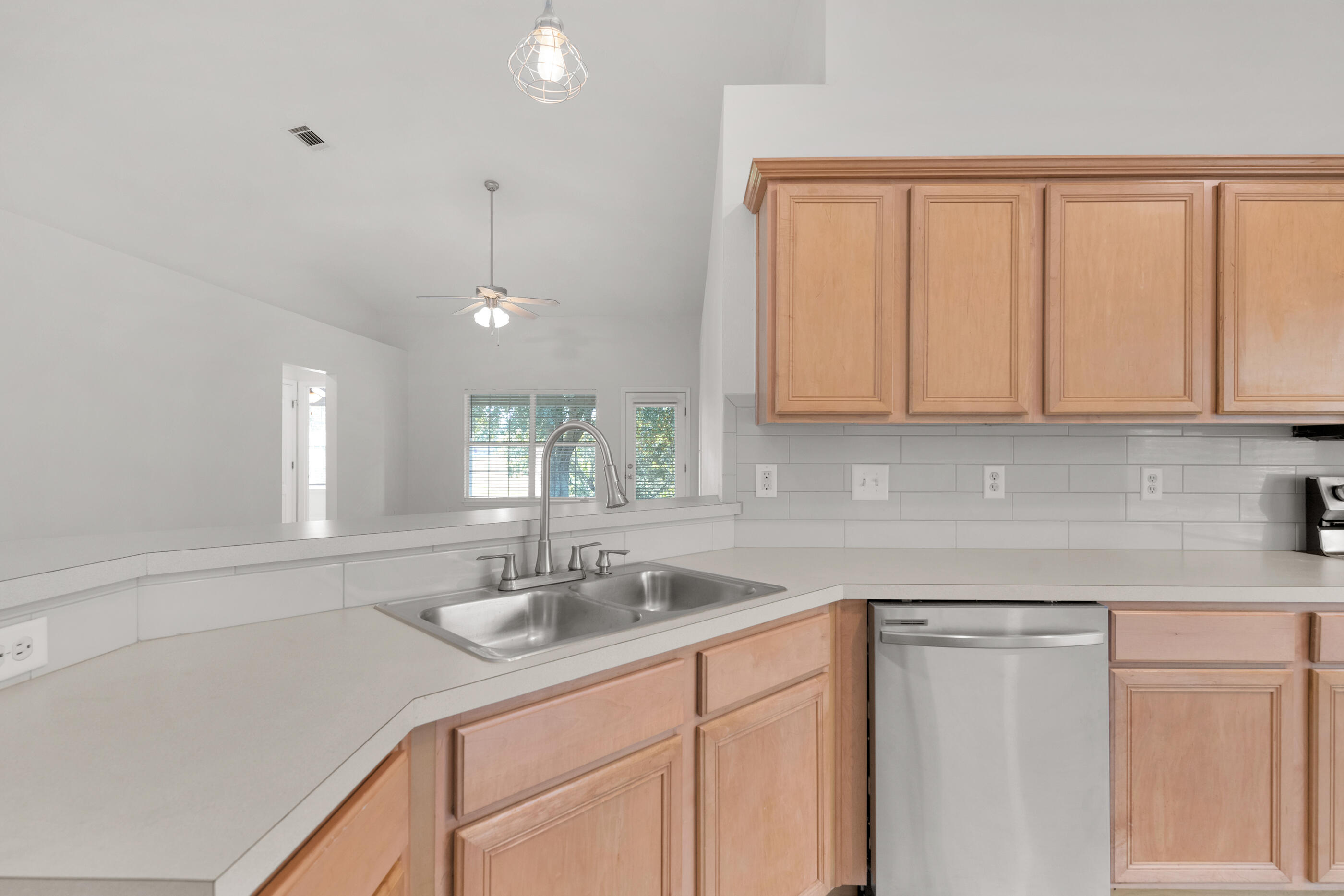 161 South Harborview Road Santa Rosa Beach, FL 32459 - Photo 16 of 39 a kitchen with sink cabinets and chandelier