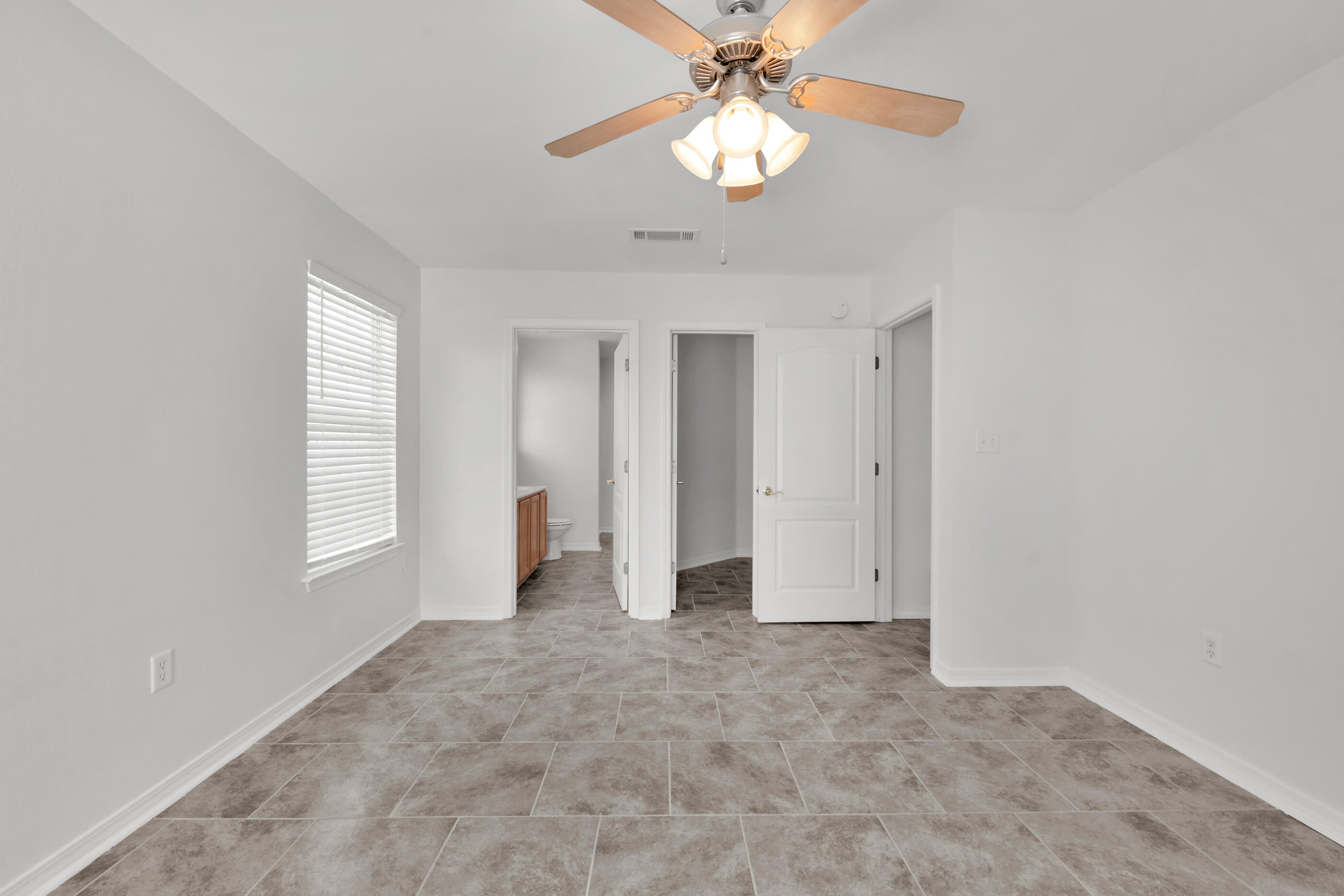 161 South Harborview Road Santa Rosa Beach, FL 32459 - Photo 24 of 39 an empty room with chandelier fan and windows