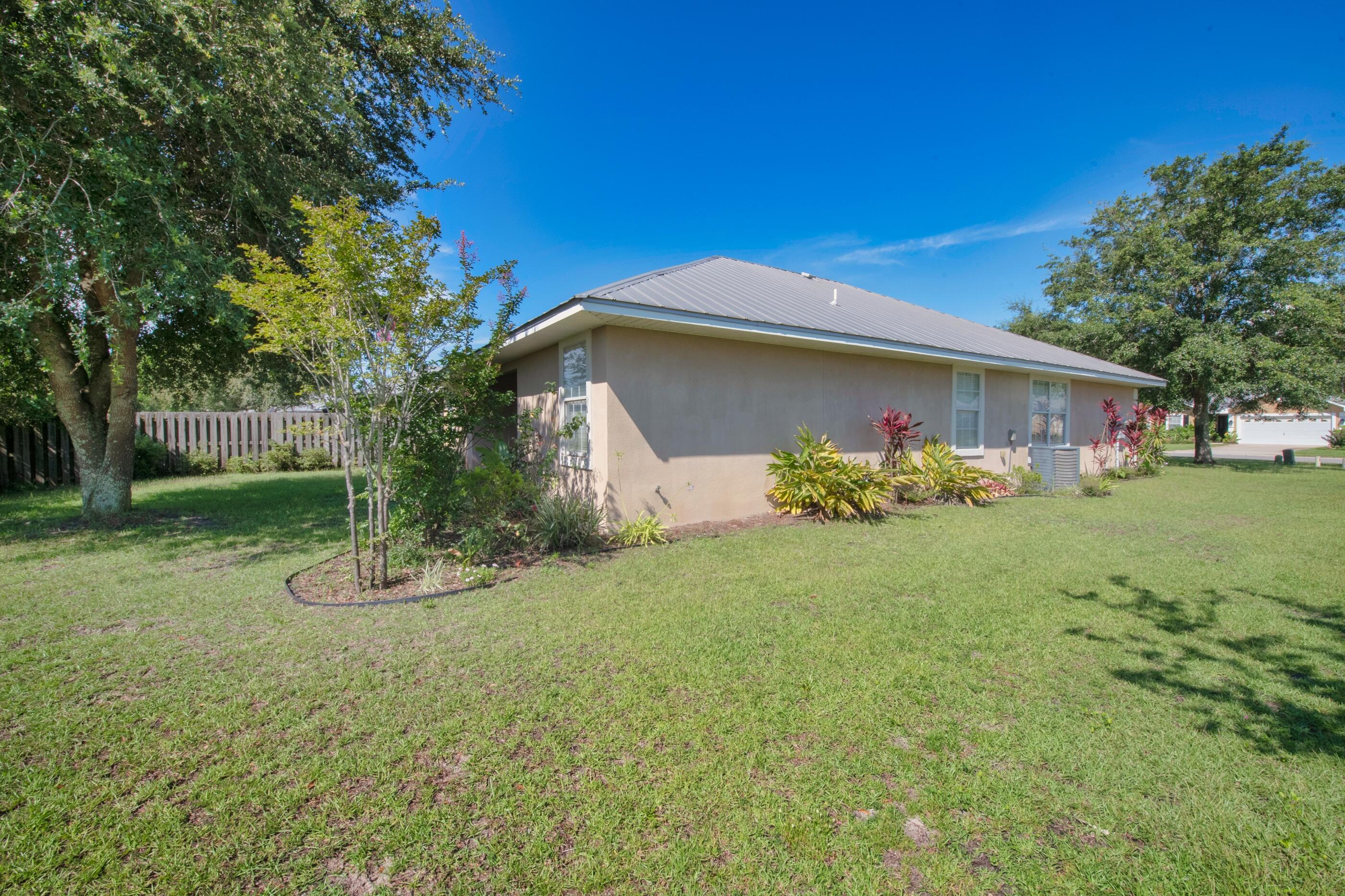161 South Harborview Road Santa Rosa Beach, FL 32459 - Photo 37 of 39 a backyard of a house with lots of green space