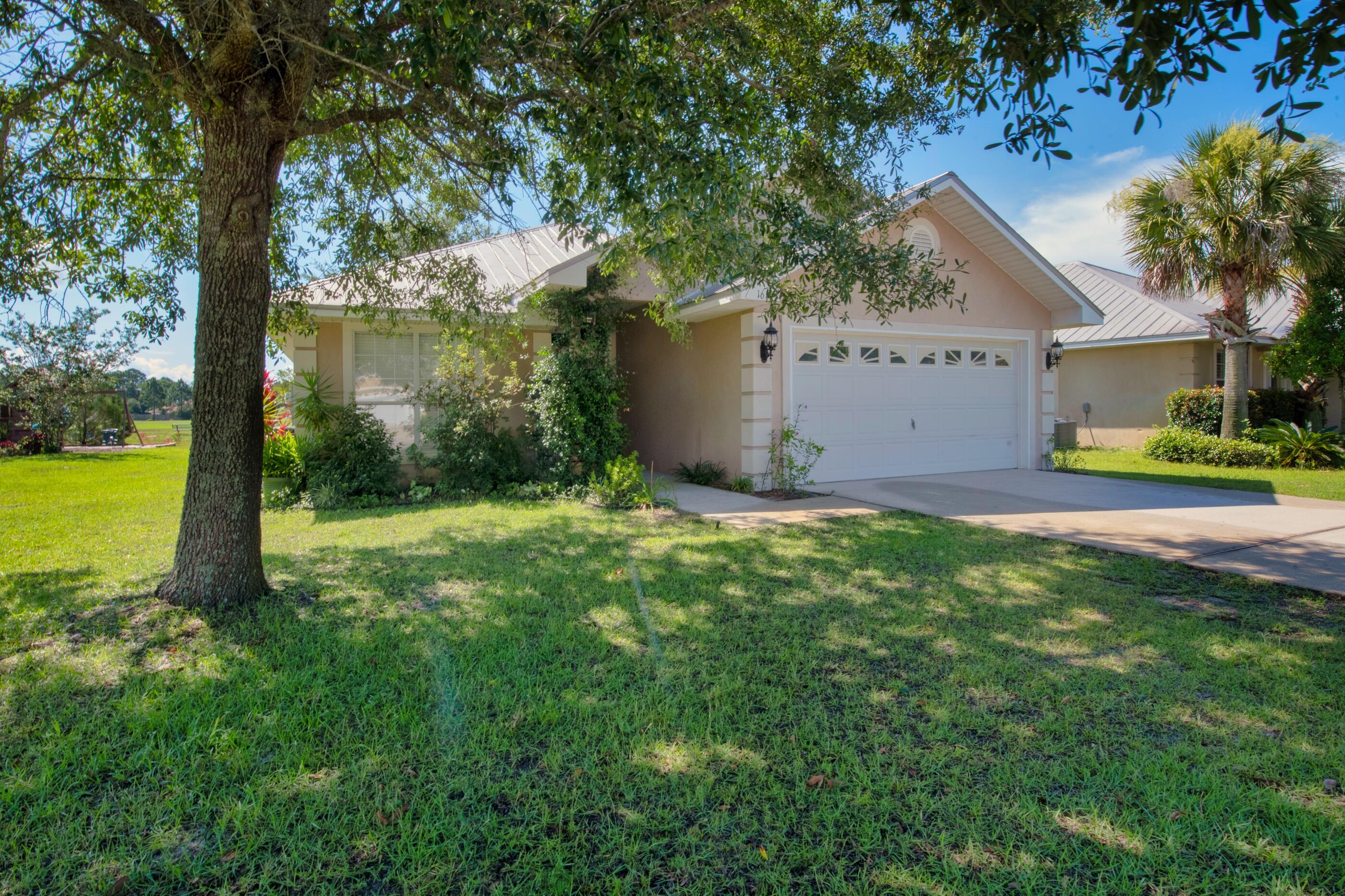 161 South Harborview Road Santa Rosa Beach, FL 32459 - Photo 4 of 39 a view of a house with a yard and tree s