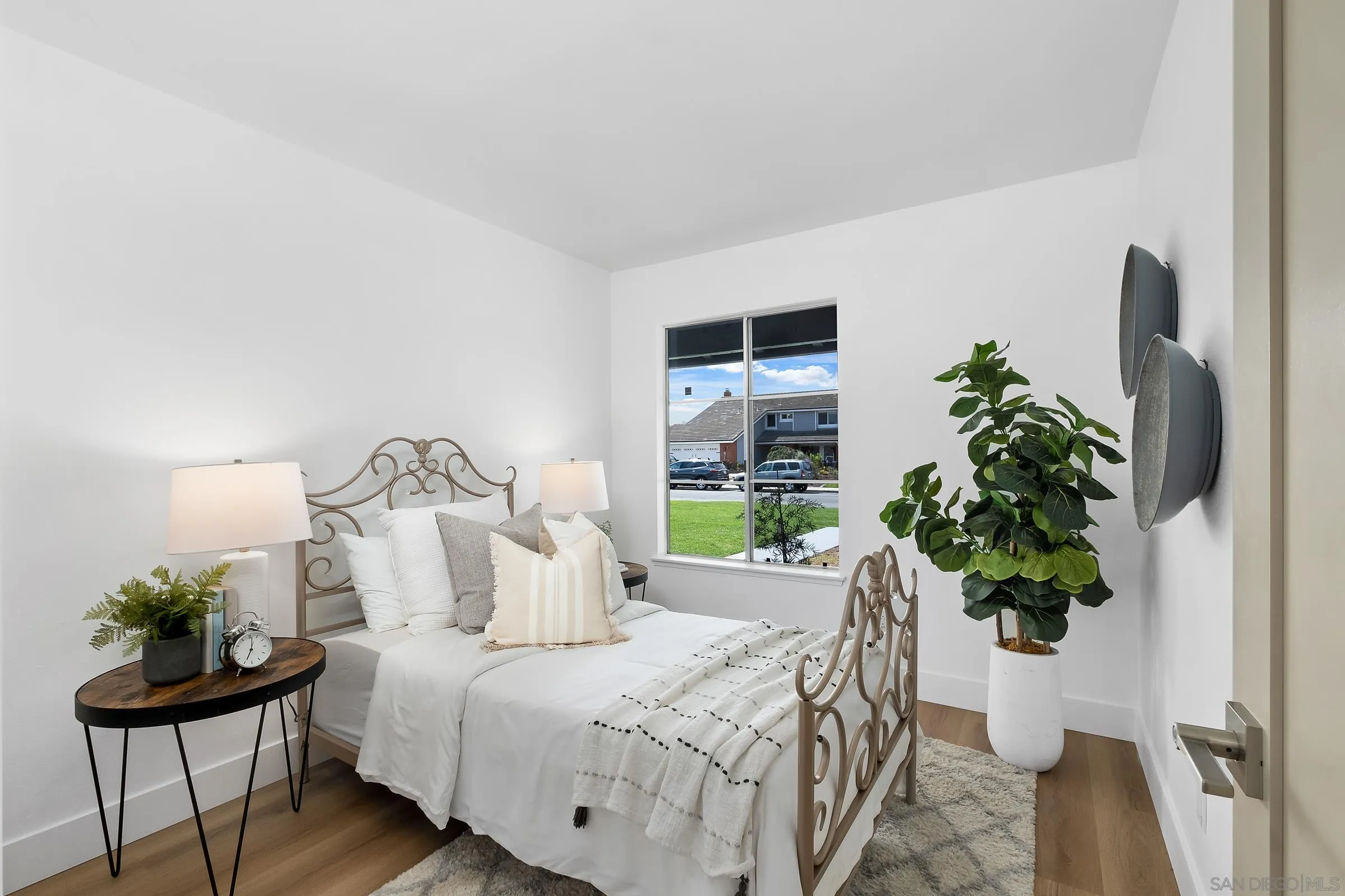 4436 Point Vicente Oceanside, CA 92058 - Photo 15 of 23 a bed sitting in a bedroom next to a potted plant