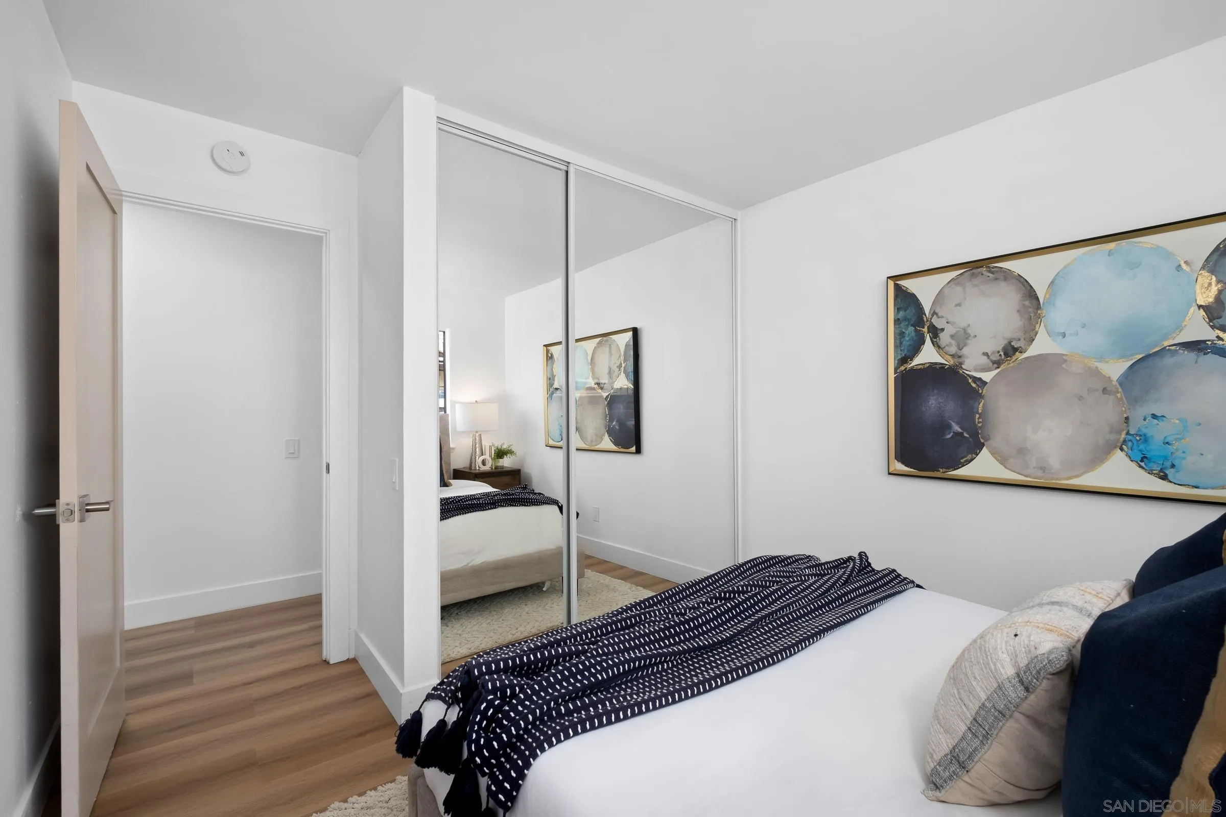 4436 Point Vicente Oceanside, CA 92058 - Photo 18 of 23 a bedroom with a bed and wooden floor