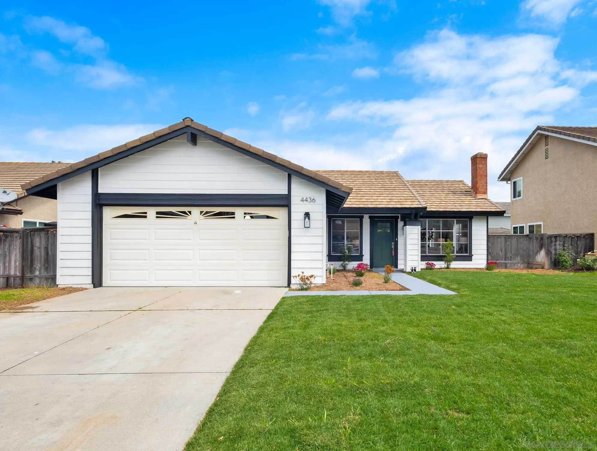 4436 Point Vicente Oceanside, CA 92058 - Photo 2 of 23 a front view of a house with a yard and garage