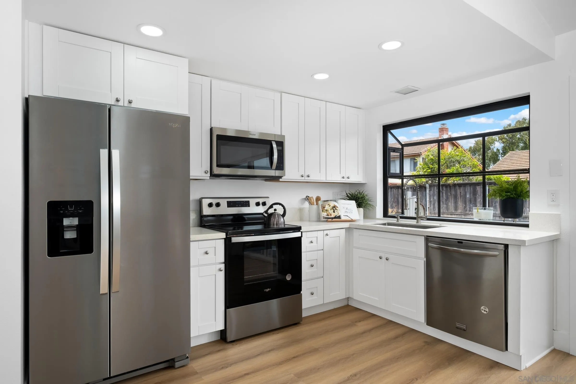 4436 Point Vicente Oceanside, CA 92058 - Photo 9 of 23 a kitchen with stainless steel appliances a refrigerator stove and microwave