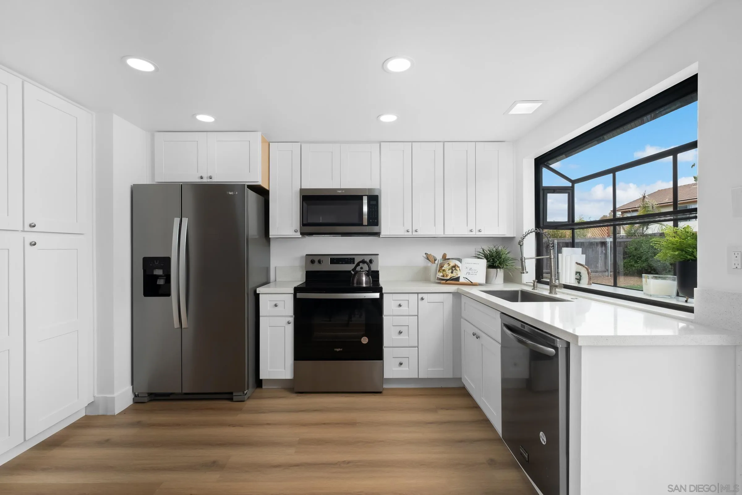 4436 Point Vicente Oceanside, CA 92058 - Photo 10 of 23 a kitchen with a refrigerator and a sink