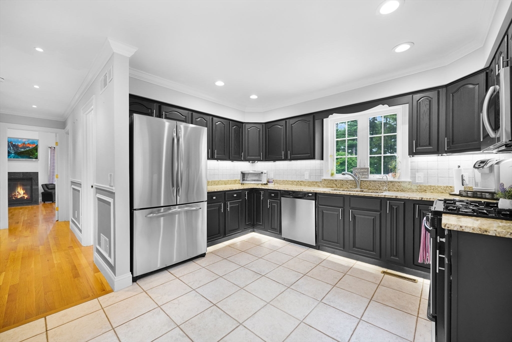 489 Main Street Acushnet, MA 02743 - Photo 12 of 37 a kitchen with granite countertop a refrigerator and a stove top oven