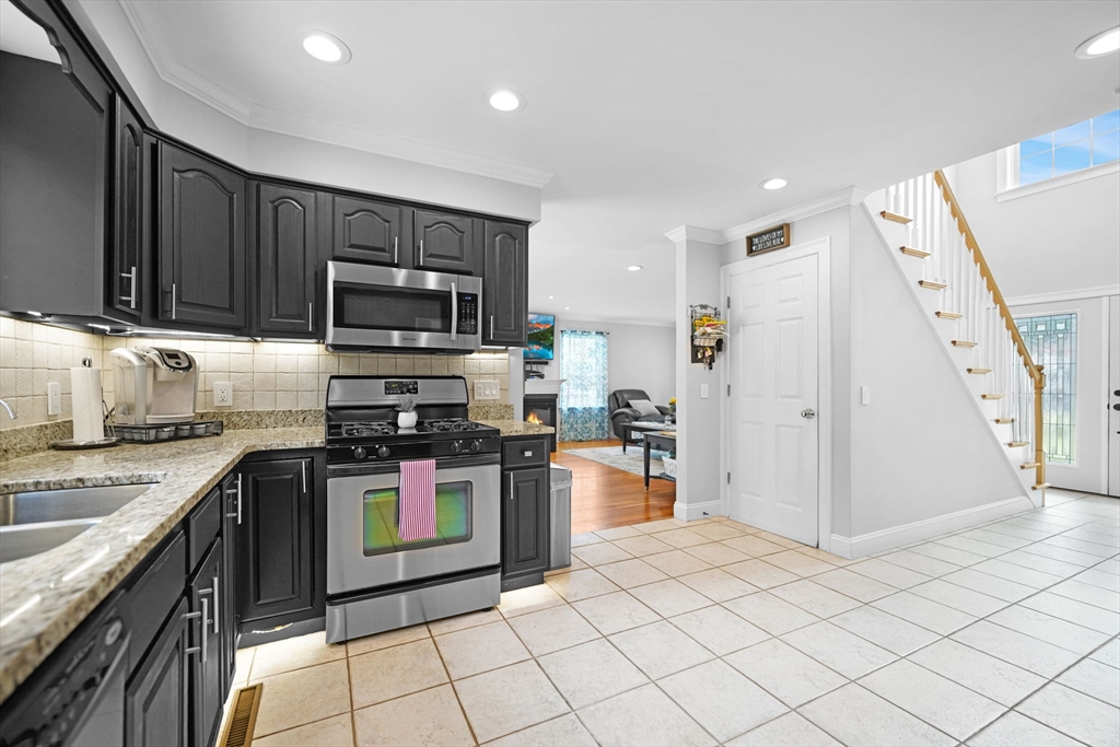 489 Main Street Acushnet, MA 02743 - Photo 14 of 37 a kitchen with stainless steel appliances granite countertop a stove a sink and a refrigerator