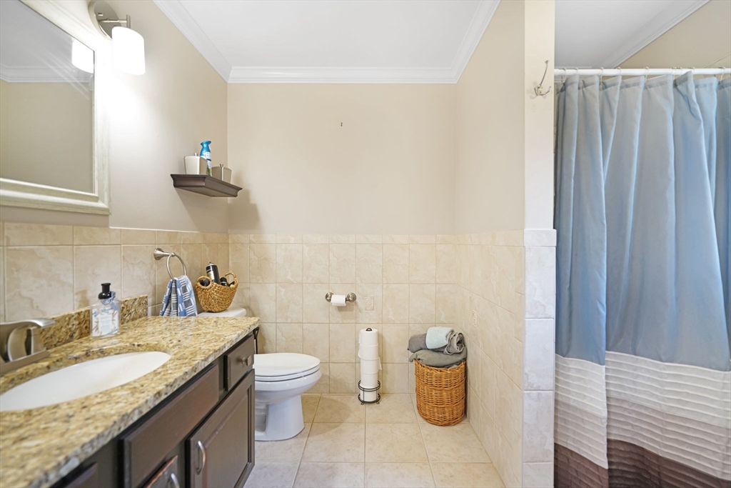489 Main Street Acushnet, MA 02743 - Photo 18 of 37 a bathroom with a granite countertop sink a toilet and a mirror