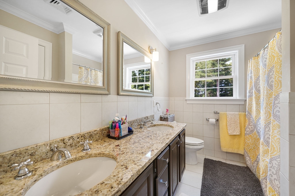 489 Main Street Acushnet, MA 02743 - Photo 21 of 37 a bathroom with a granite countertop sink a mirror and a bathtub