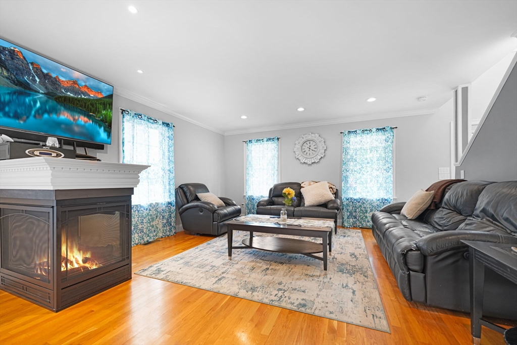 489 Main Street Acushnet, MA 02743 - Photo 7 of 37 a living room with furniture a flat screen tv and a fireplace