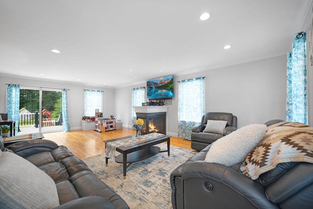 489 Main Street Acushnet, MA 02743 - Photo 10 of 37 a living room with furniture fireplace and a large window