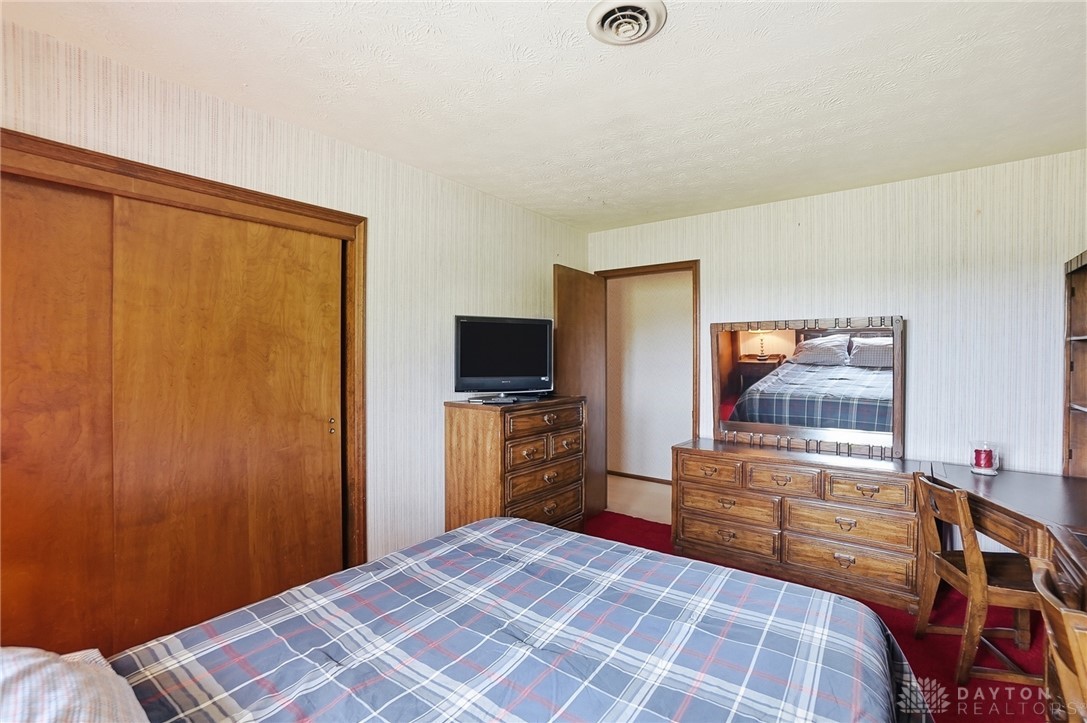 5669 O Neall Road Waynesville, OH 45068 - Photo 42 of 72 This cozy bedroom features warm wood finishes and practical built-in elements, perfect for comfortable living.