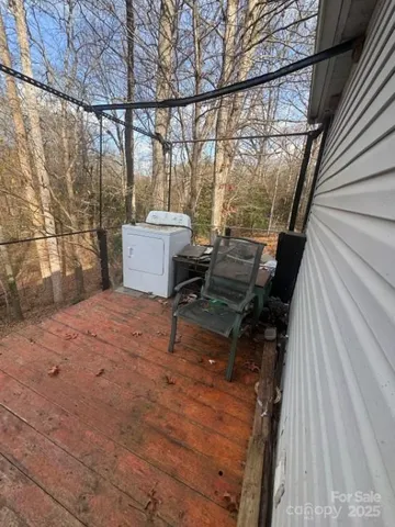 a view of a terrace with wooden floor and iron fence