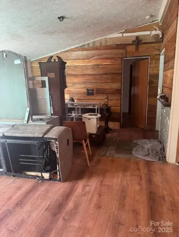a view of a room with wooden floor and furniture