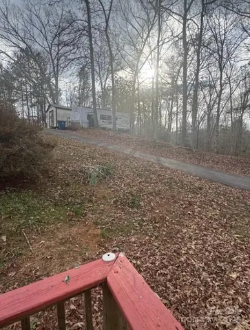 a view of a backyard with large trees
