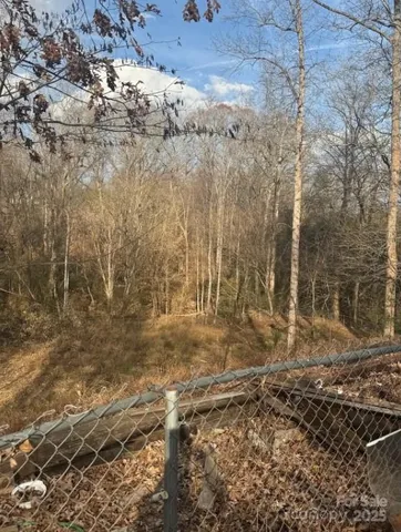 a view of trees with yard