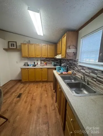 a kitchen with a sink and wooden cabinets