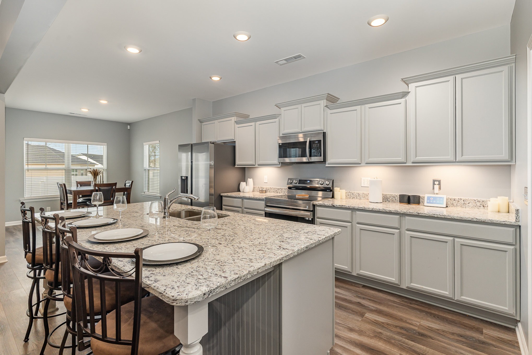 248 Ruby Cate Way Murfreesboro, TN 37128 - Photo 11 of 29 a kitchen with sink stove microwave and dining table