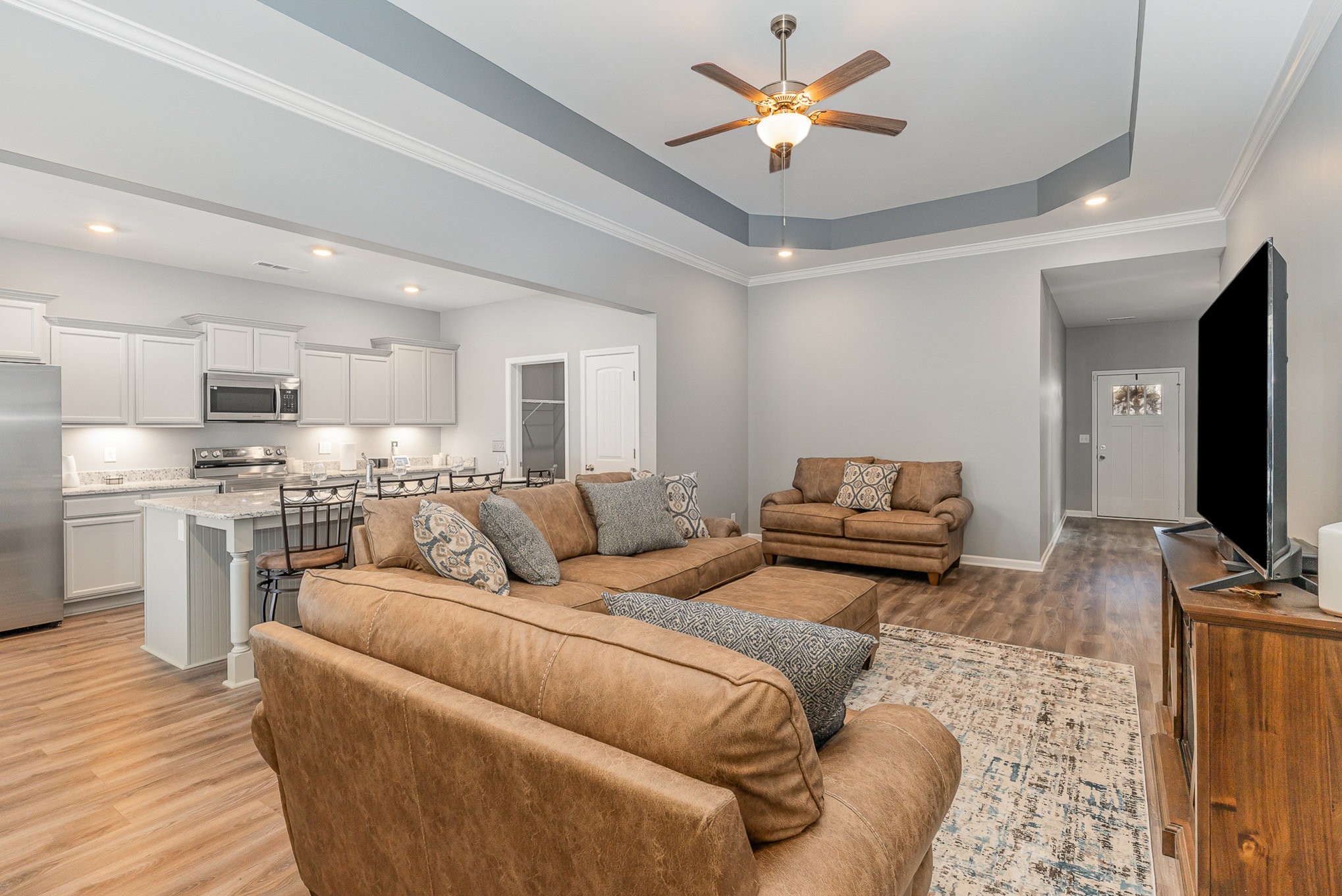 248 Ruby Cate Way Murfreesboro, TN 37128 - Photo 6 of 29 a living room with furniture kitchen view and a flat screen tv